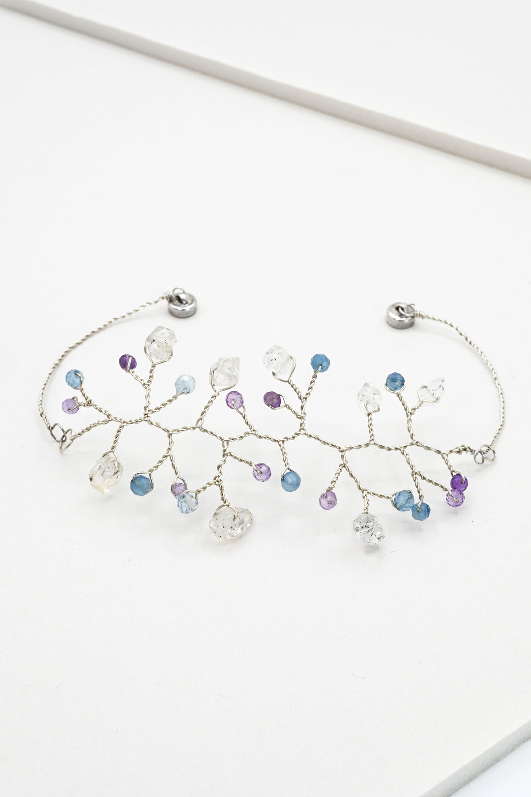 Sterling silver vine bracelet with herkimer quartz "diamonds" and tiny amethyst and aquamarine accent beads. Magnetic clasp closure for easy wear. 