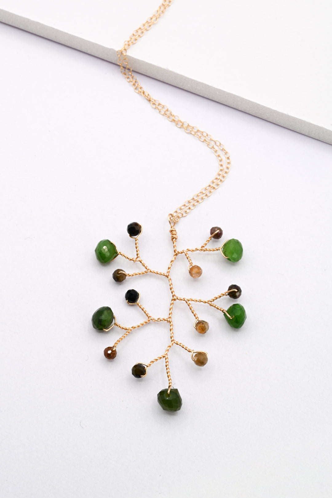 Jade and tourmaline wire vine pendant on a delicate gold necklace chain by J'Adorn Designs
