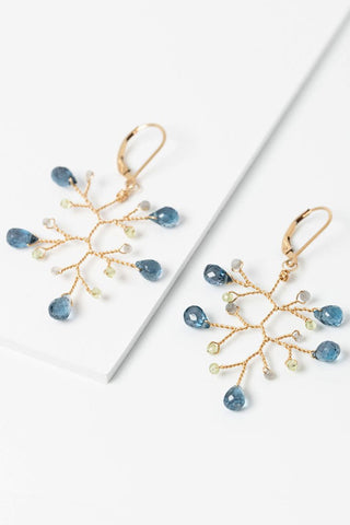 Flay lay of London blue topaz, peridot, and labradorite gold branch earrings. Lightweight statement earrings inspired by nature, made by jewelry artist Alison Jefferies for J'Adorn Designs Custom Jewelry.