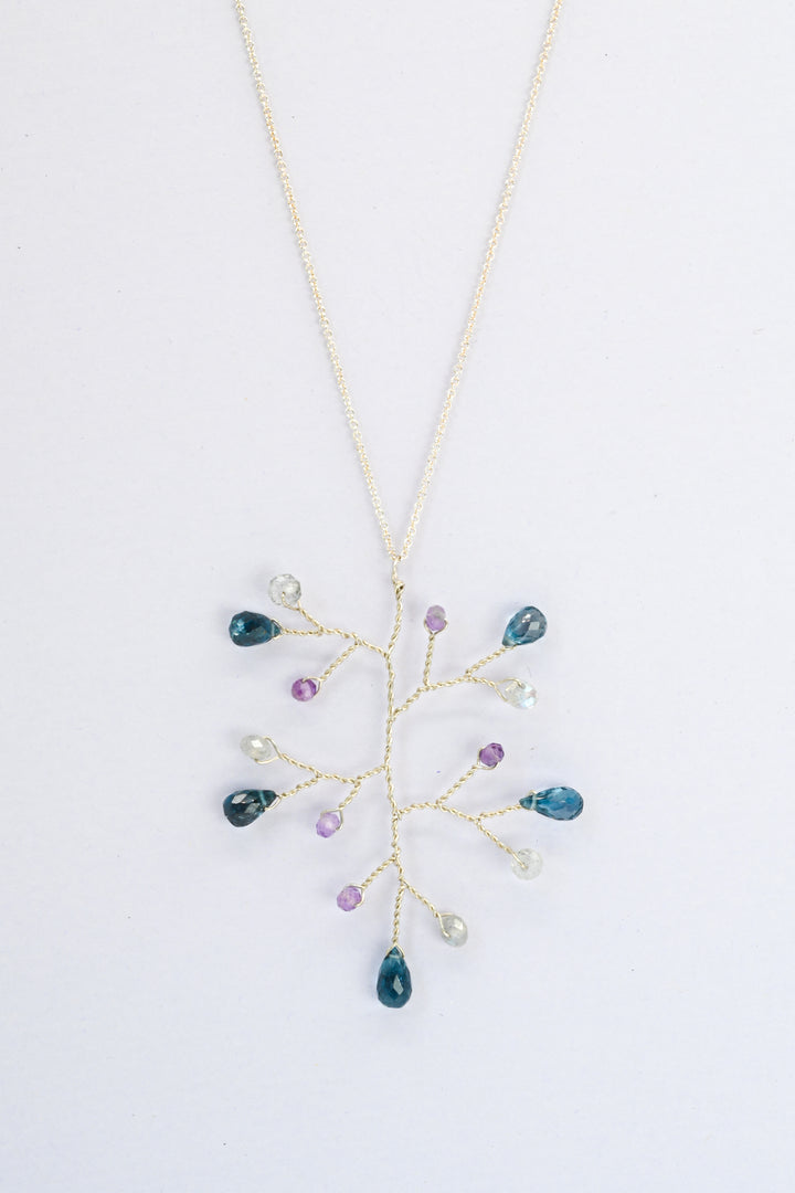 Delicate silver wire wrapped branch necklace with London blue topaz teardrops and accent beads in amethyst and labradorite, on a delicate sterling silver chain