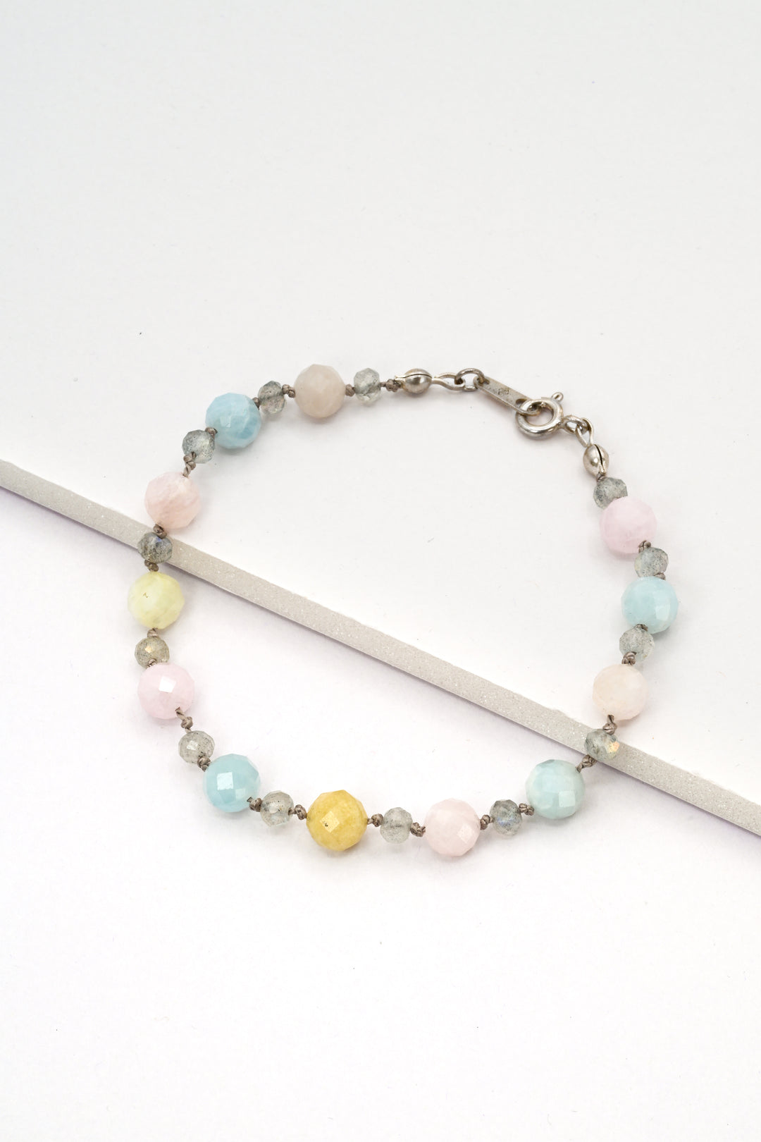 Pastel rainbow morganite gemstone bracelet with silver labradorite accents and a sterling silver clasp.