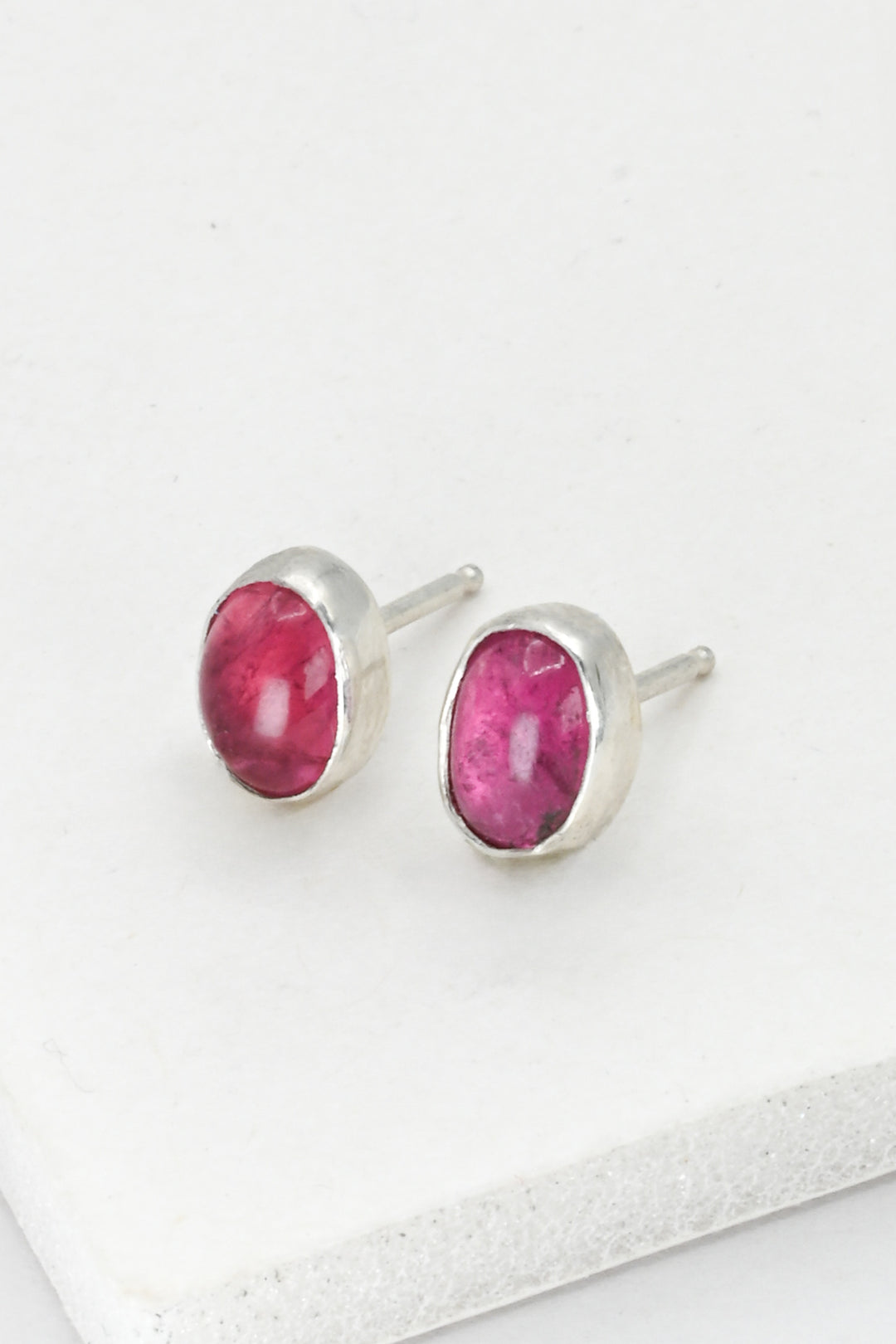 One pair of bezel set pink tourmaline post earrings in sterling silver, by J'Adorn Designs.