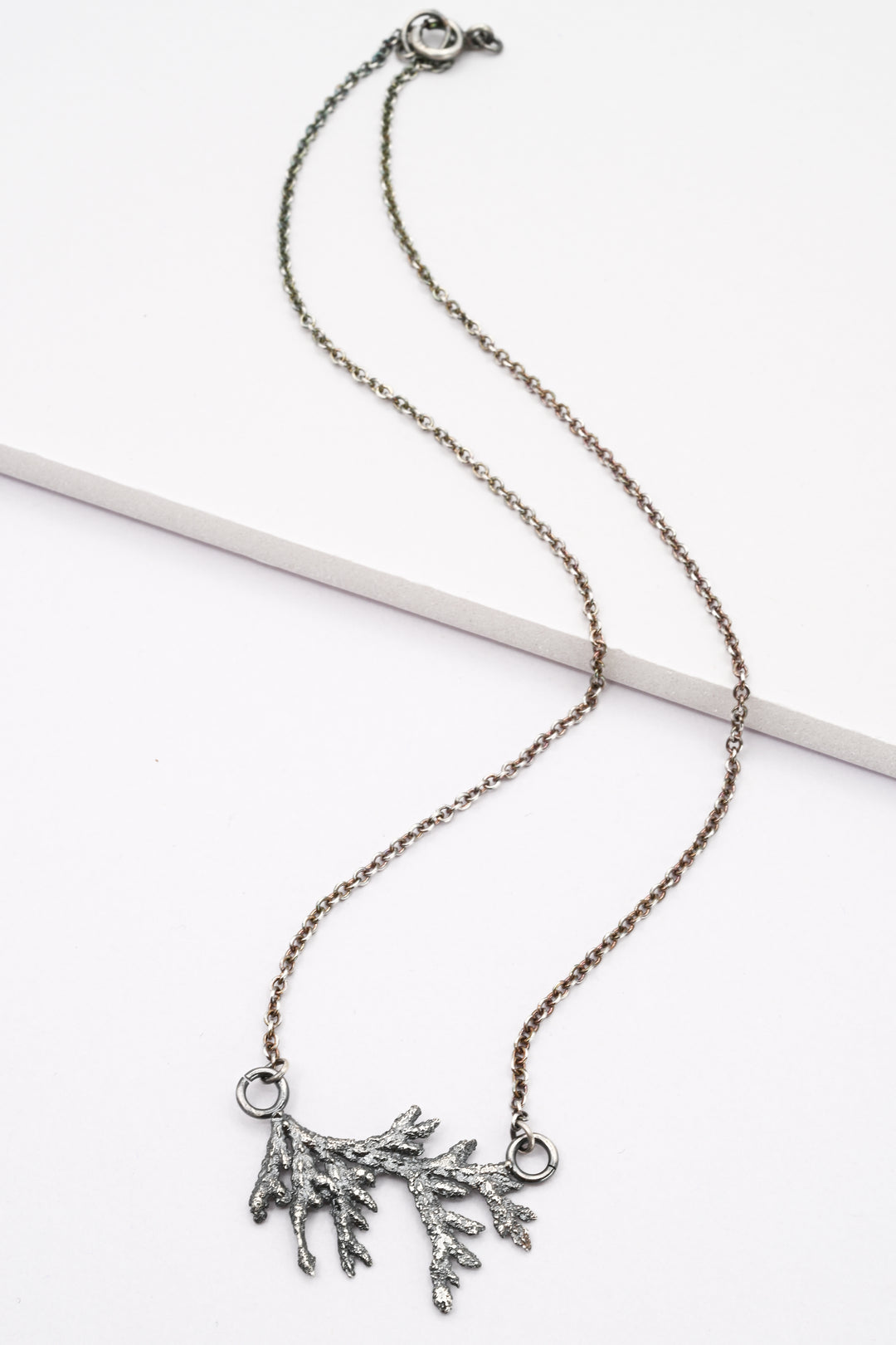 Cast evergreen side pendant necklace in oxidized sterling silver by J'Adorn Designs