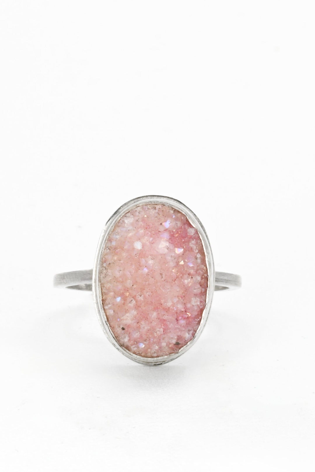 Frontal view of a pink bezel-set oval druzy on a square sterling silver band by J'Adorn Designs