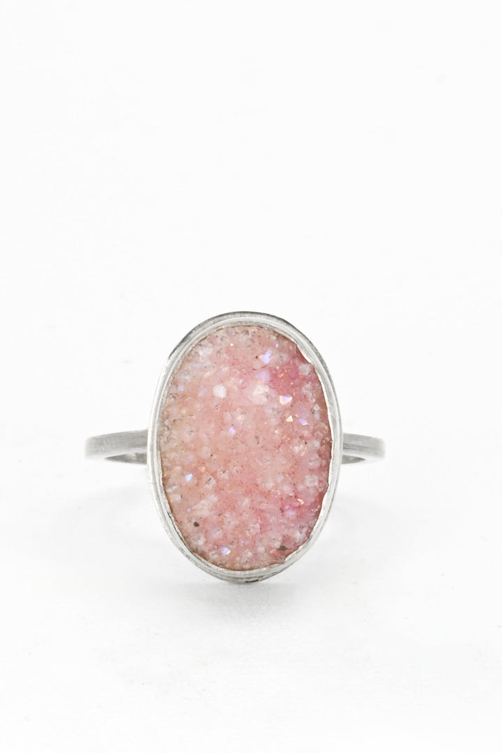 Frontal view of a pink bezel-set oval druzy on a square sterling silver band by J'Adorn Designs