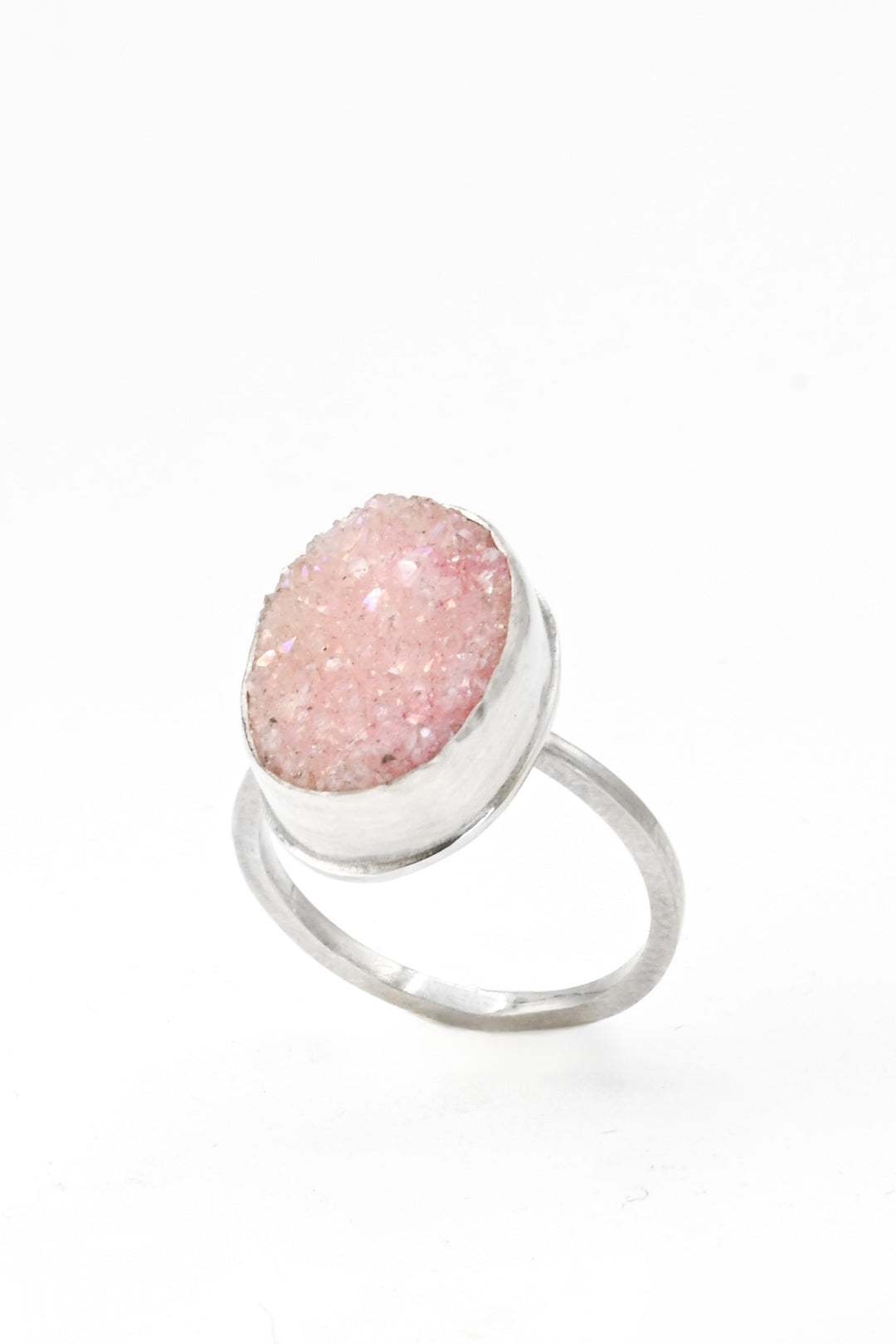 Angled view of a pink bezel-set oval druzy on a square sterling silver band by J'Adorn Designs