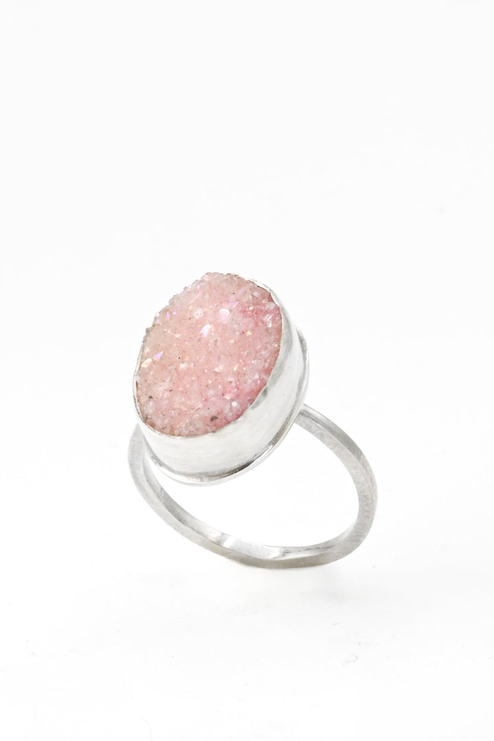 Angled view of a pink bezel-set oval druzy on a square sterling silver band by J'Adorn Designs