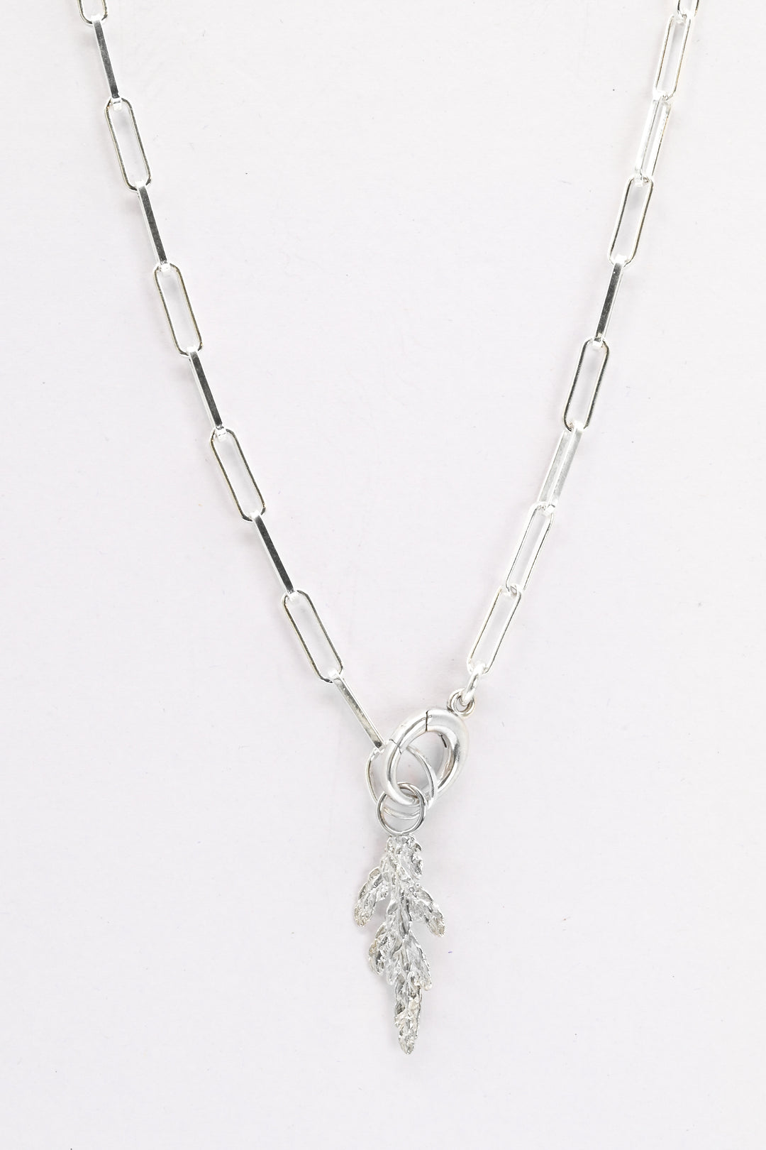 Sterling silver paperclip chain necklace with charm holder clasp and a small silver evergreen charm
