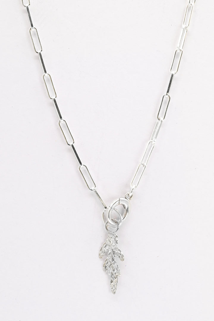 Sterling silver paperclip chain necklace with charm holder clasp and a small silver evergreen charm