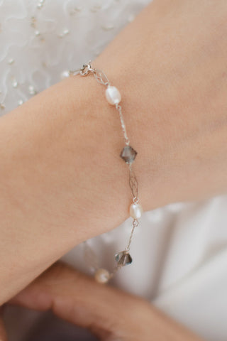 Delicate sterling silver link bracelet with white freshwater pearls, grey swarovski crystals, and silver filigree links by Alison Jefferies for J'Adorn Designs