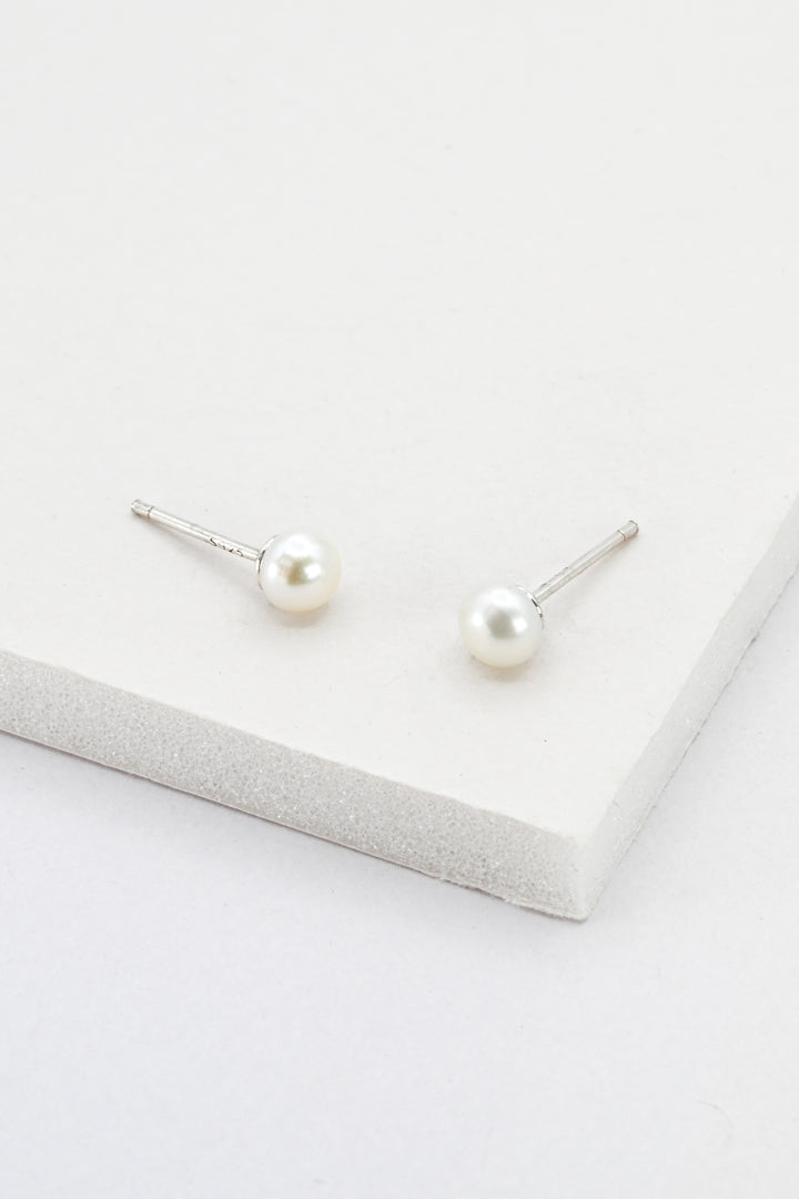 A pair of small pearl stud earrings with sterling silver posts