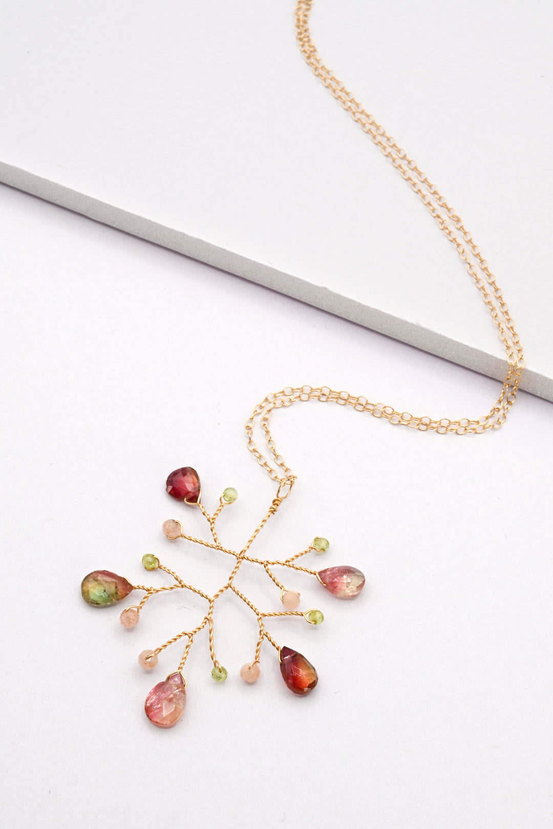 Watermelon tourmaline wire branch pendant necklace on a white background, by J'Adorn Designs.