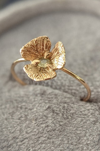 14k gold hand sculpted flower ring with yellow sapphire center cast into place via lost wax casting method. Delicate gold flower ring by Alison Jefferies of J'Adorn Designs.