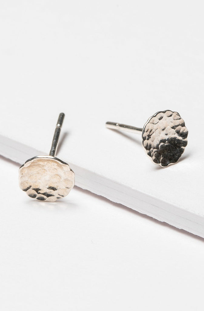 Small hammered sterling silver disc stud earrings. Artisan jewelry and luxury bridal accessories handmade in Maryland by Alison Jefferies of J'Adorn Designs.