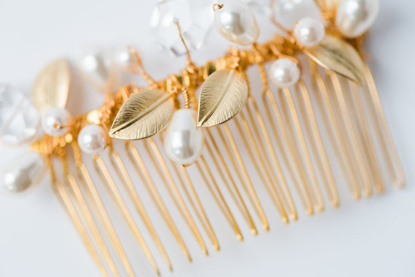 Close up detail shot of an heirloom quality gold plated hair comb is adorned with hand-wired ivory pearls, genuine crystal quartz gemstone nuggets, and gold leaves. Handmade bridal comb for wedding hairstyles, formals, and special occasions for years to come by jewelry artisan Alison Jefferies for J'Adorn Designs.