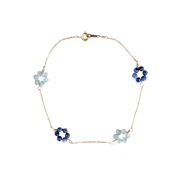 Delicate gold chain and blue gemstone flower bracelet. Aquamarine and kyanite daisy chain bracelet by jewelry artisan Alison Jefferies of J'Adorn Designs