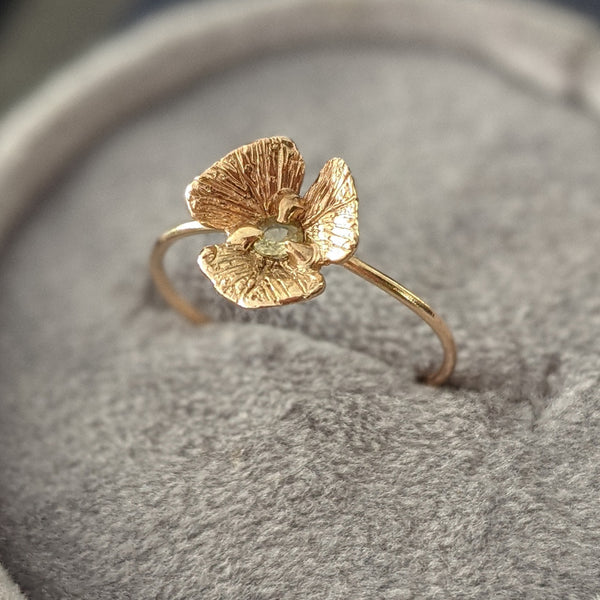 14k gold hand sculpted flower ring with yellow sapphire center cast into place via lost wax casting method. Delicate gold flower ring by Alison Jefferies of J'Adorn Designs.