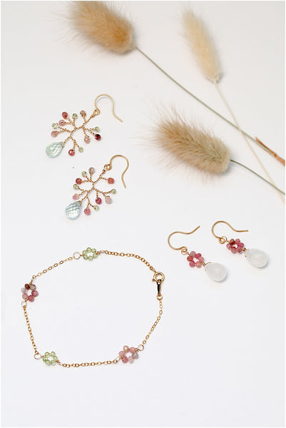 Spring jewelry set in pink, blue, green, and gold. Delicate wire-wrapped branch earrings in gold with peridot, tourmaline, and aquamarine gemstones. Handcrafted artisan jewelry by Alison Jefferies for J'Adorn Designs custom jewelry and modern bridal accessories.