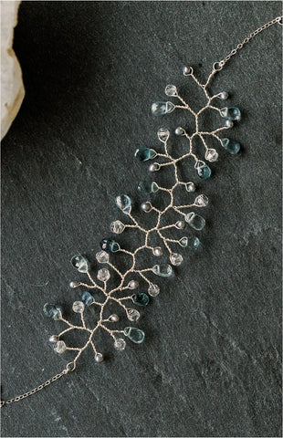 A delicate aquamarine and silver freshwater pearl vine bracelet made by hand with sterling silver wire by J'Adorn Designs fine jewelry artisan Alison Jefferies of Baltimore, Maryland. March birthstone bracelet with aquamarines. Something blue bracelet for a luxury wedding.