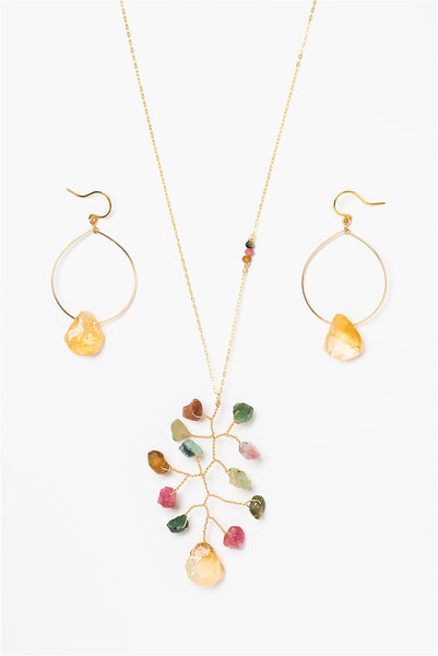 Long asymmetrical necklace with rough rainbow tourmaline and citrine gemstones in a wire wrapped branch design. Coordinated gold hoop earrings with rough citrine drops. Gold jewelry set made by J'Adorn Designs artisan Alison Jefferies of Baltimore, MD.