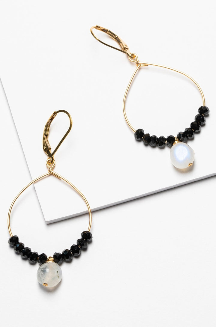 Black and gold handcrafted hoop earrings for sale. A pair of delicate gold hoops with black spinel and moonstone bead accents for luxury fashion or a jewelry gift idea. Artisan jewelry and luxury bridal accessories handmade in Maryland by Alison Jefferies of J'Adorn Designs.
