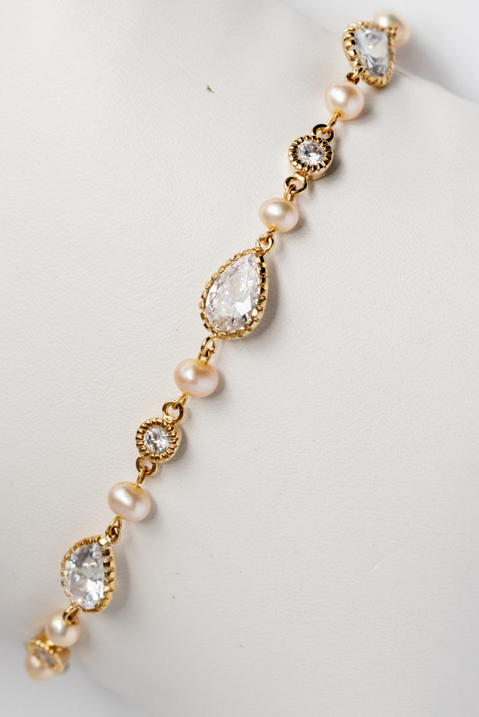 Pear shaped bridal bracelet with golden pearls; gold bridal bracelet by J'Adorn Designs custom wedding jewelry and modern bridal accessories