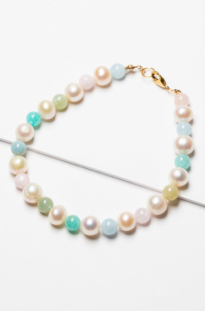 A beautiful rainbow inspired pearl bracelet made with freshwater pearls and multicolored beryl beads with a gold filled clasp. Artisan jewelry by J'Adorn Designs.