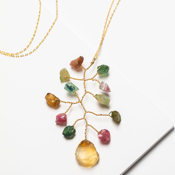 Long asymmetrical necklace with rough rainbow tourmaline and citrine gemstones in a wire wrapped branch design made by J'Adorn Designs artisan Alison Jefferies of Baltimore, MD.