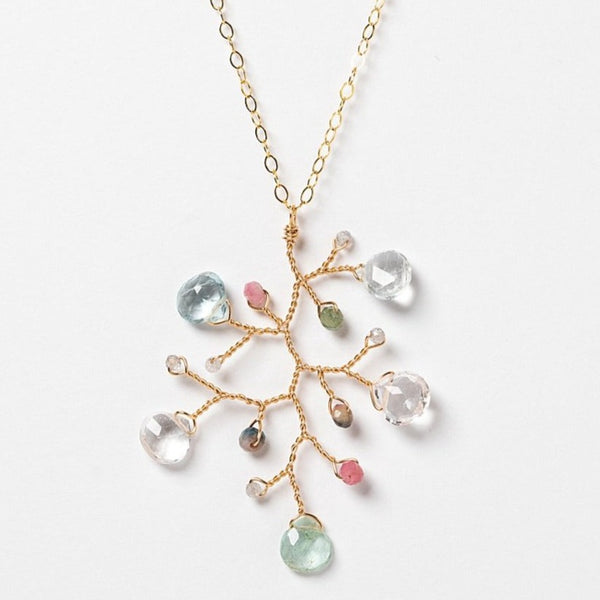 One handcrafted gold pendant featuring a wire-wrapped branch with aquamarine teardrops and tourmaline beads in a rainbow of colors. A lightweight, hypoallergenic gemstone necklace on a fine 14k gold filled chain. Artisan jewelry made by Alison Jefferies for J'Adorn Designs.