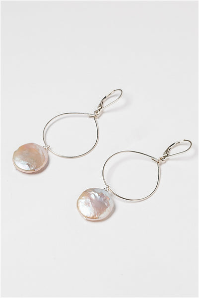 Lightweight silver hoop earrings with large pearl drops. Freshwater coin pearls on a thin silver hoop earrings. Handcrafted jewelry and modern bridal accessories by J'Adorn Designs artist Alison Jefferies.