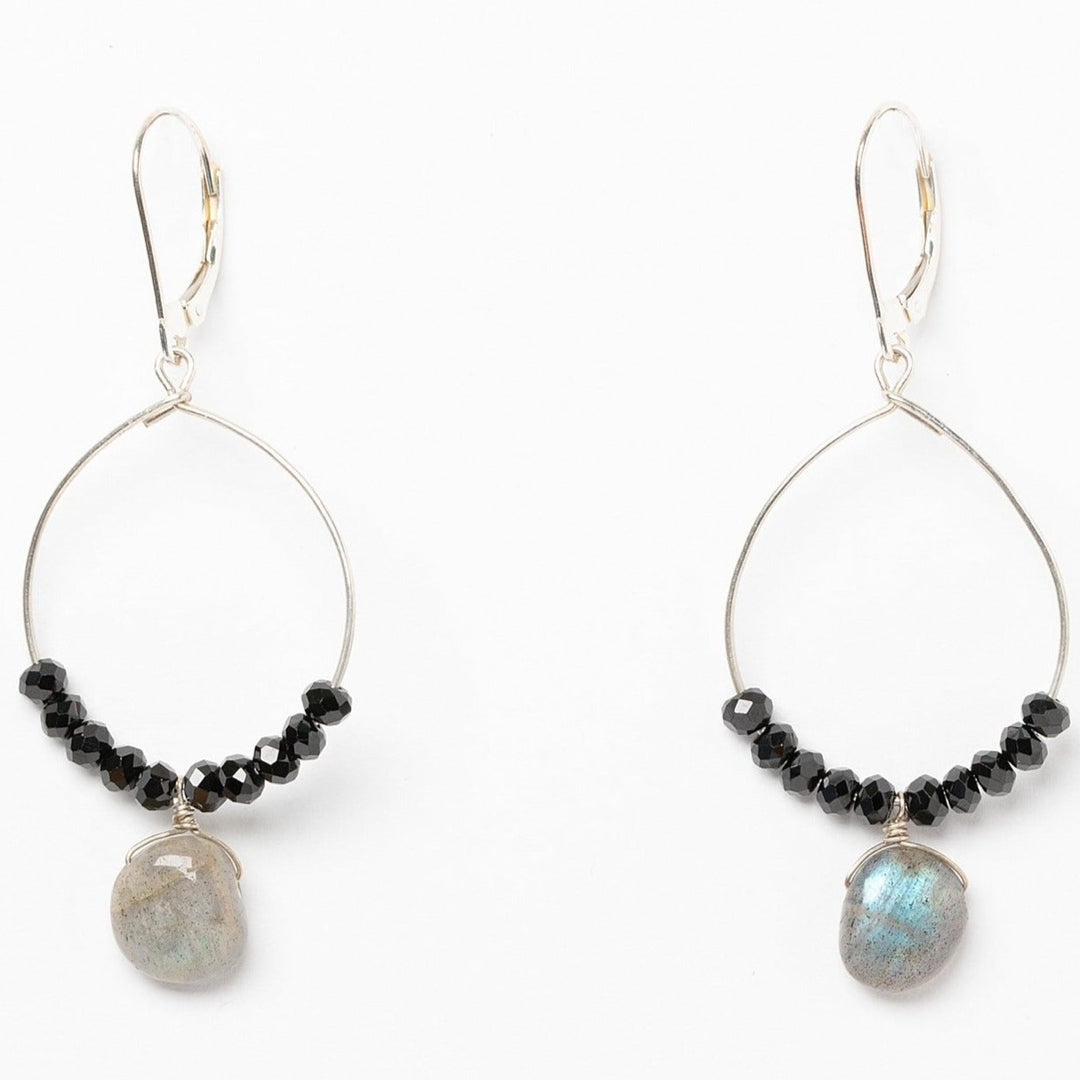 A pair of black and silver hoop earrings with black spinel and iridescent grey labradorite drops. Celestial inspired jewelry for luxury fashion or a jewelry gift idea. Artisan jewelry and luxury bridal accessories handmade in Maryland by Alison Jefferies of J'Adorn Designs.